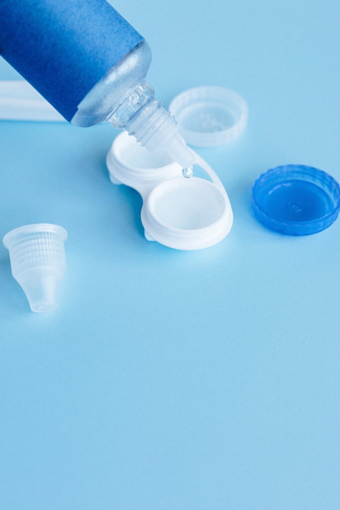 Contact lens solutions pouring into a contact lens case